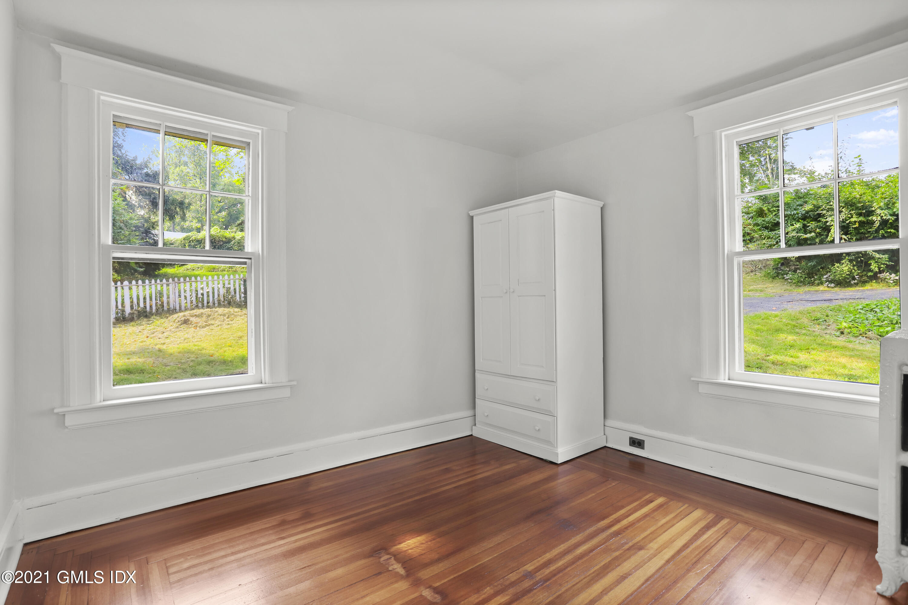 35 Strickland Road Cos Cob, CT 06807 - Photo 20 of 25 an empty room with wooden floor and windows