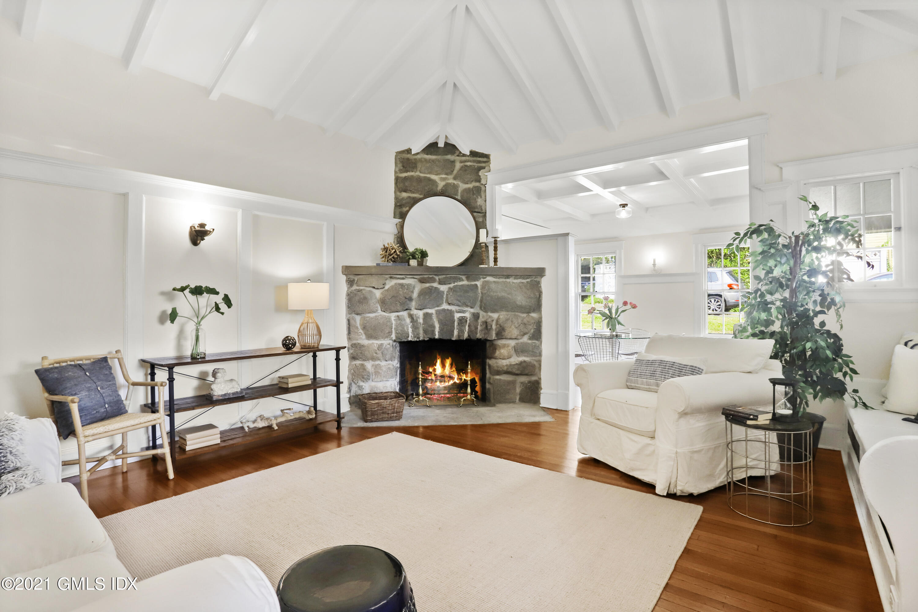 35 Strickland Road Cos Cob, CT 06807 - Photo 5 of 25 a living room with furniture a fireplace and a chandelier