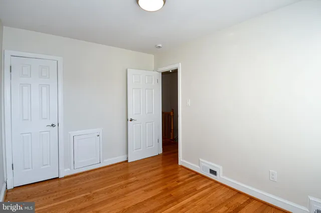 a view of a room with wooden floor and window