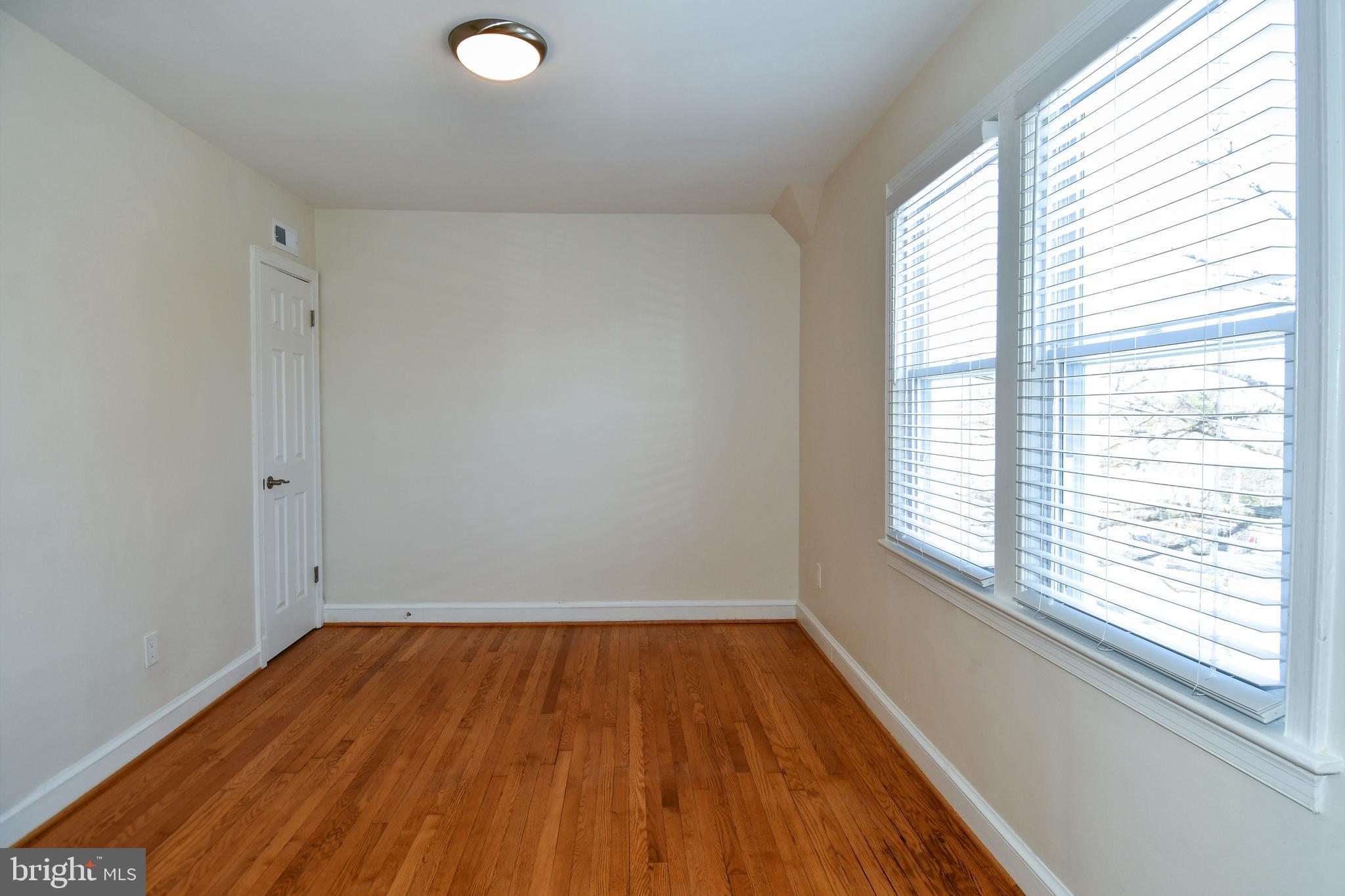 4620 Sargent Road Northeast Washington, DC 20017 - Photo 19 of 34 a view of a room with wooden floor and windows