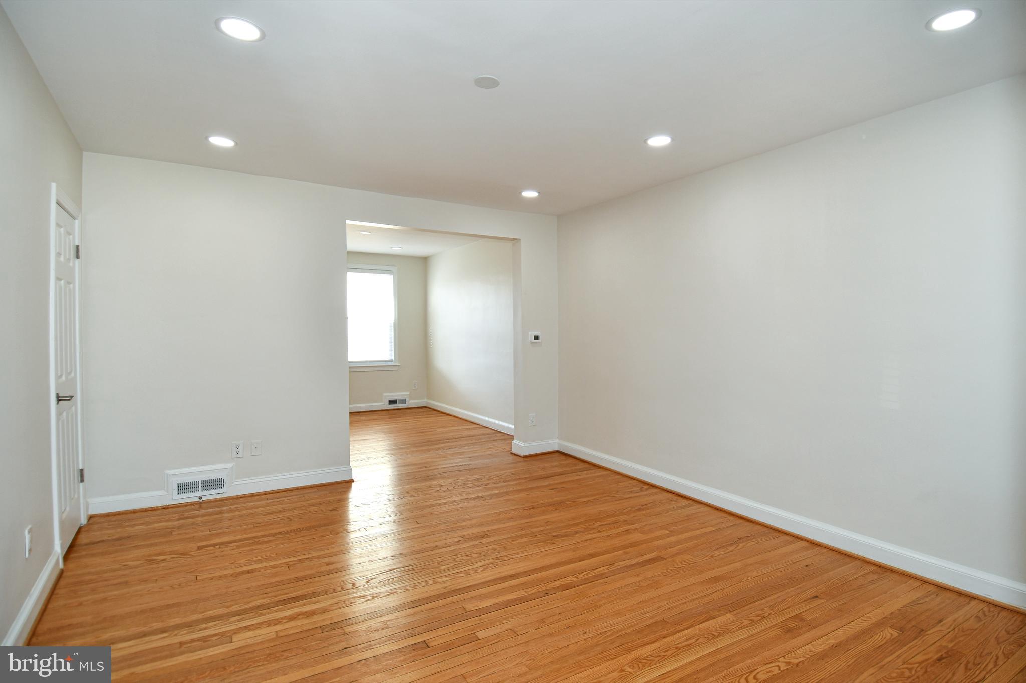 4620 Sargent Road Northeast Washington, DC 20017 - Photo 21 of 34 a view of an empty room with wooden floor and a window