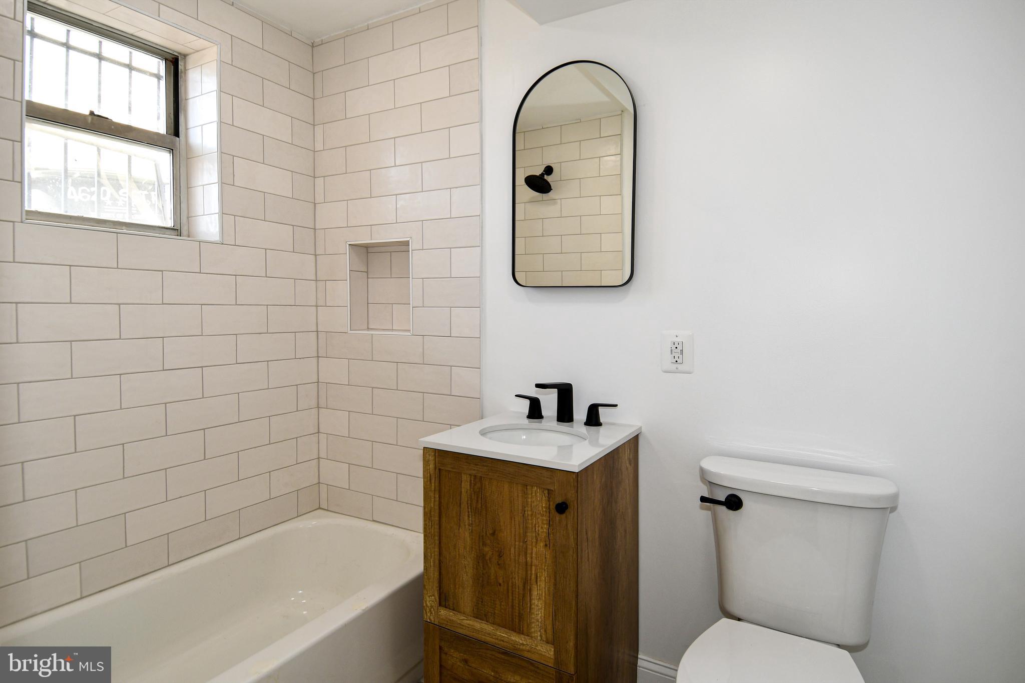 4620 Sargent Road Northeast Washington, DC 20017 - Photo 22 of 34 a bathroom with a sink toilet and tub