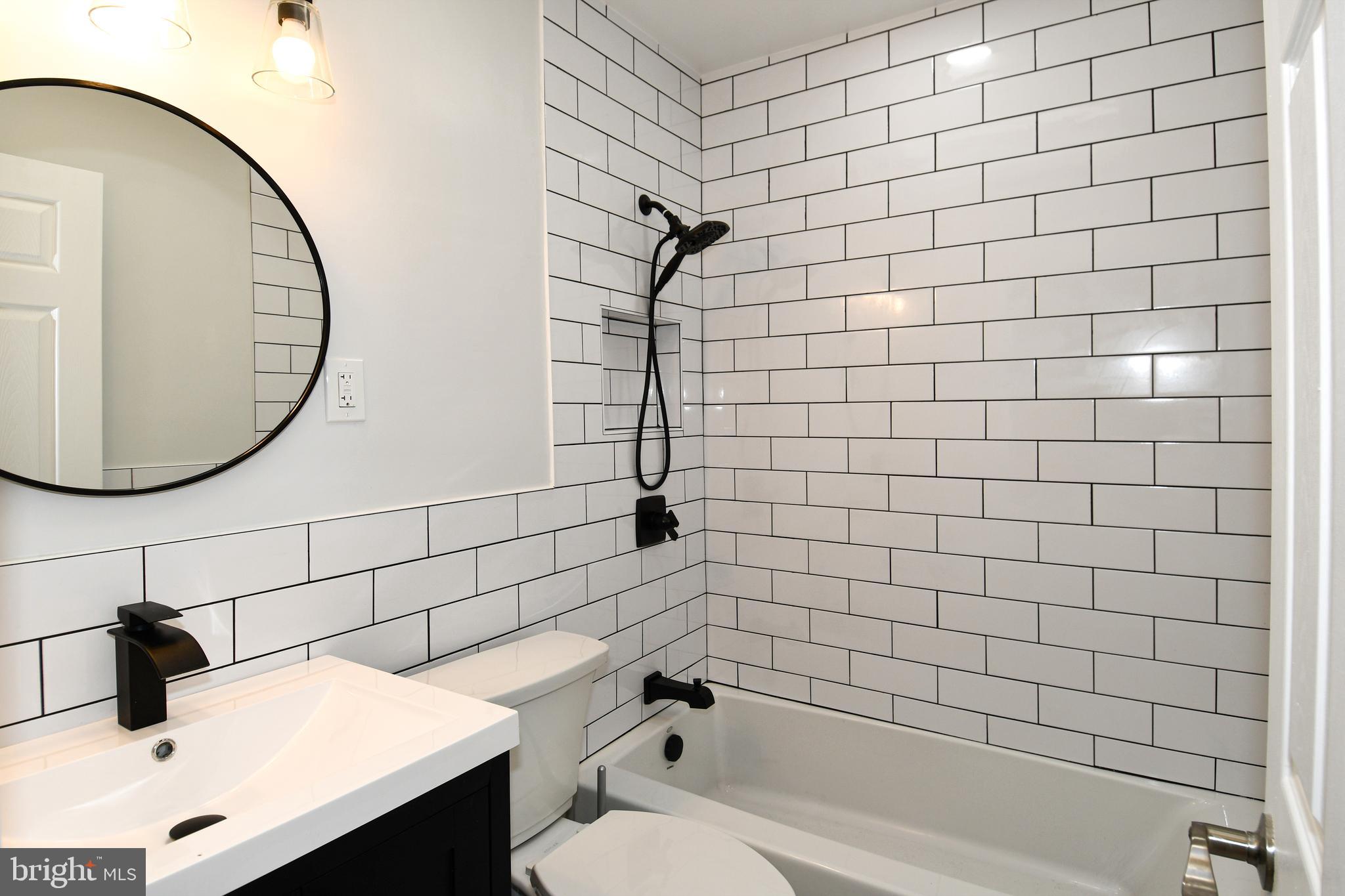 4620 Sargent Road Northeast Washington, DC 20017 - Photo 24 of 34 a bathroom with a sink a toilet and shower