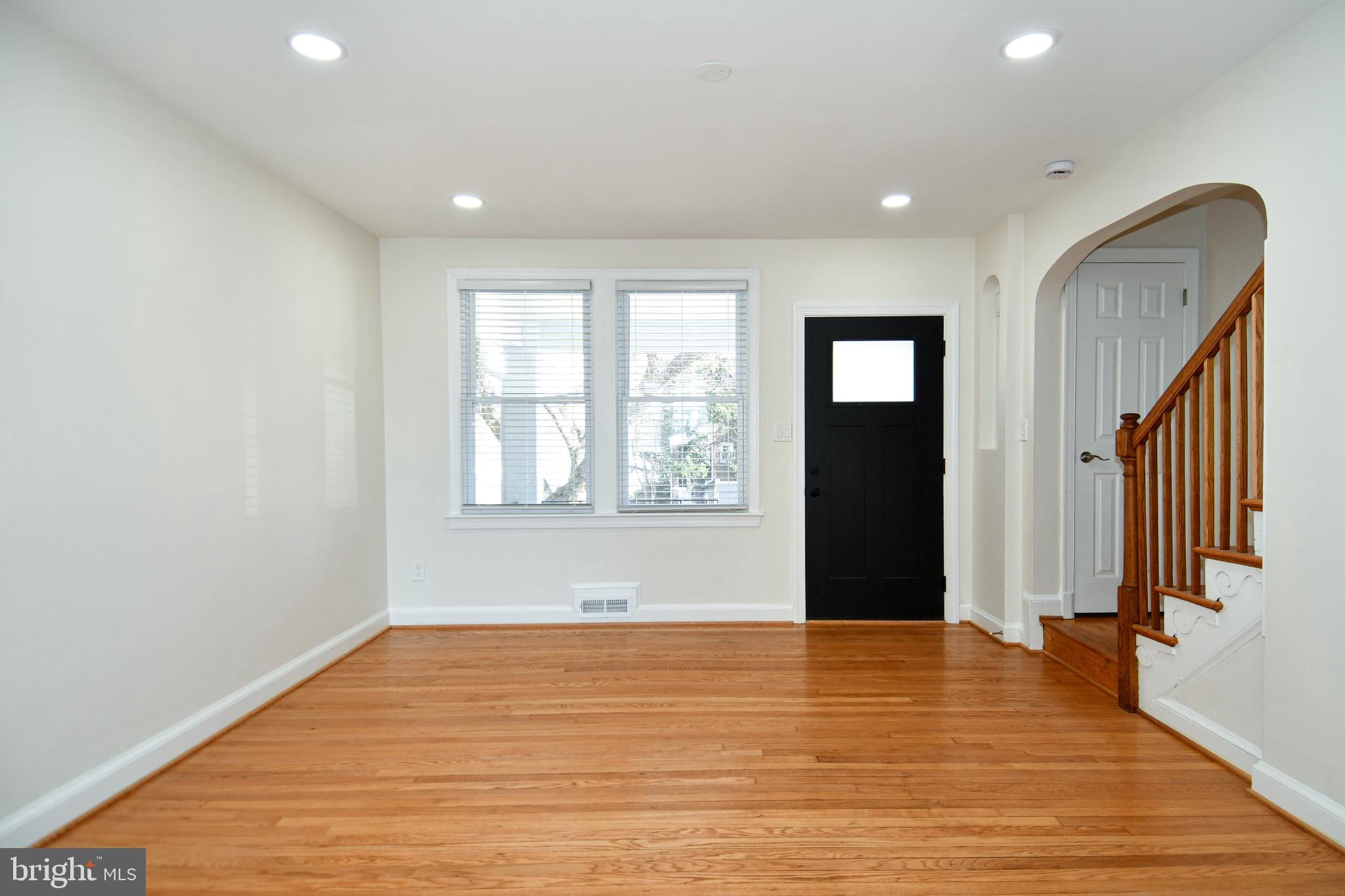 4620 Sargent Road Northeast Washington, DC 20017 - Photo 4 of 34 a view of an empty room with wooden floor and a window
