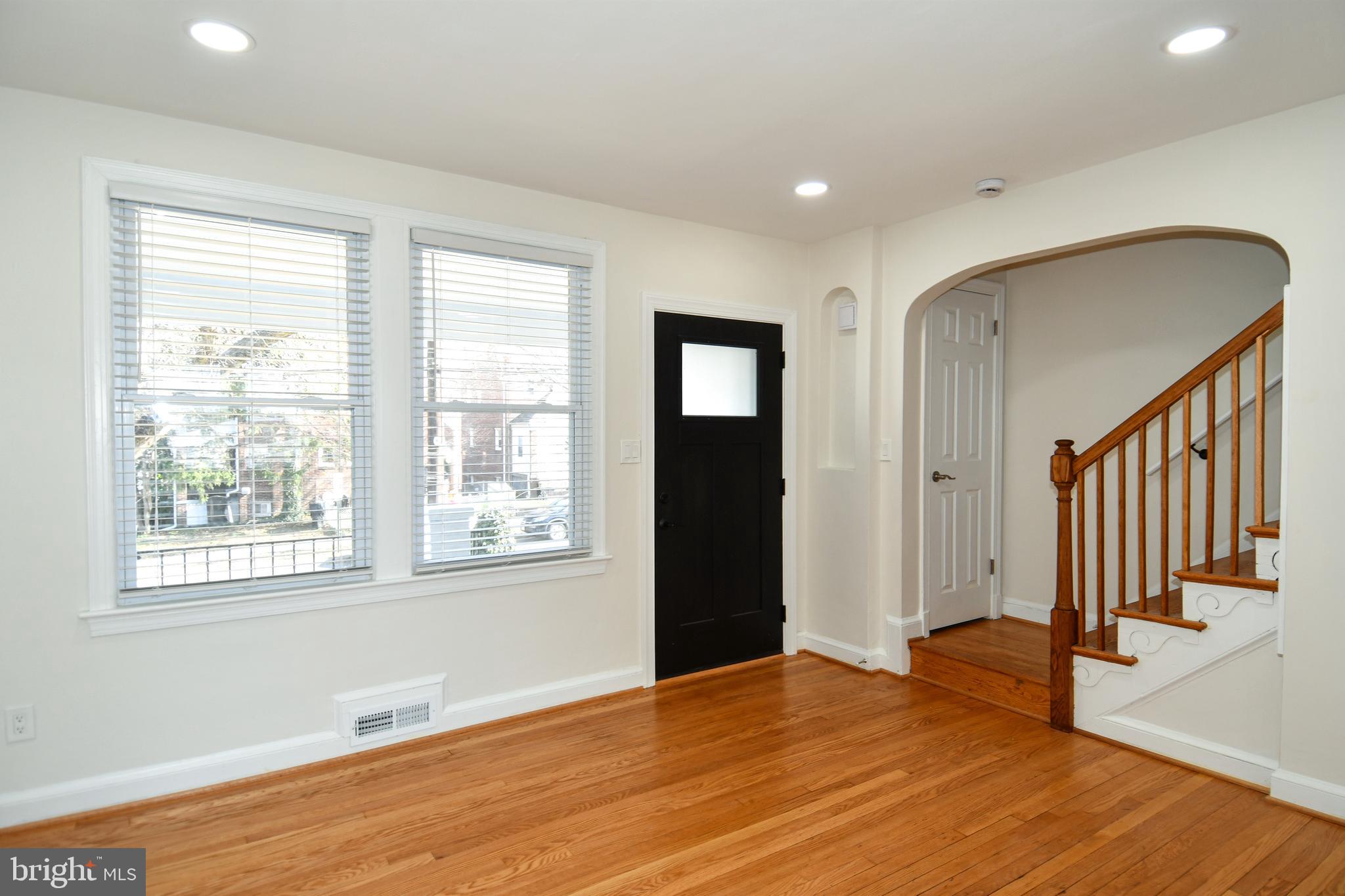 4620 Sargent Road Northeast Washington, DC 20017 - Photo 5 of 34 a view of an empty room with wooden floor and a window