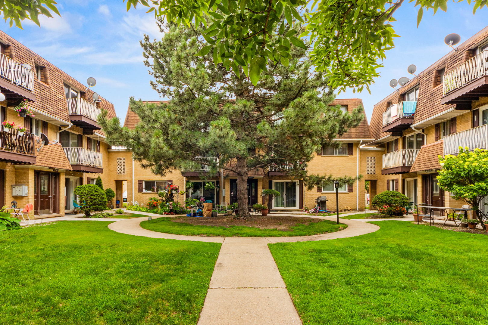 8559 West Rascher Avenue, Unit 3N Chicago, IL 60656 - Photo 2 of 15 a front view of a building with a garden