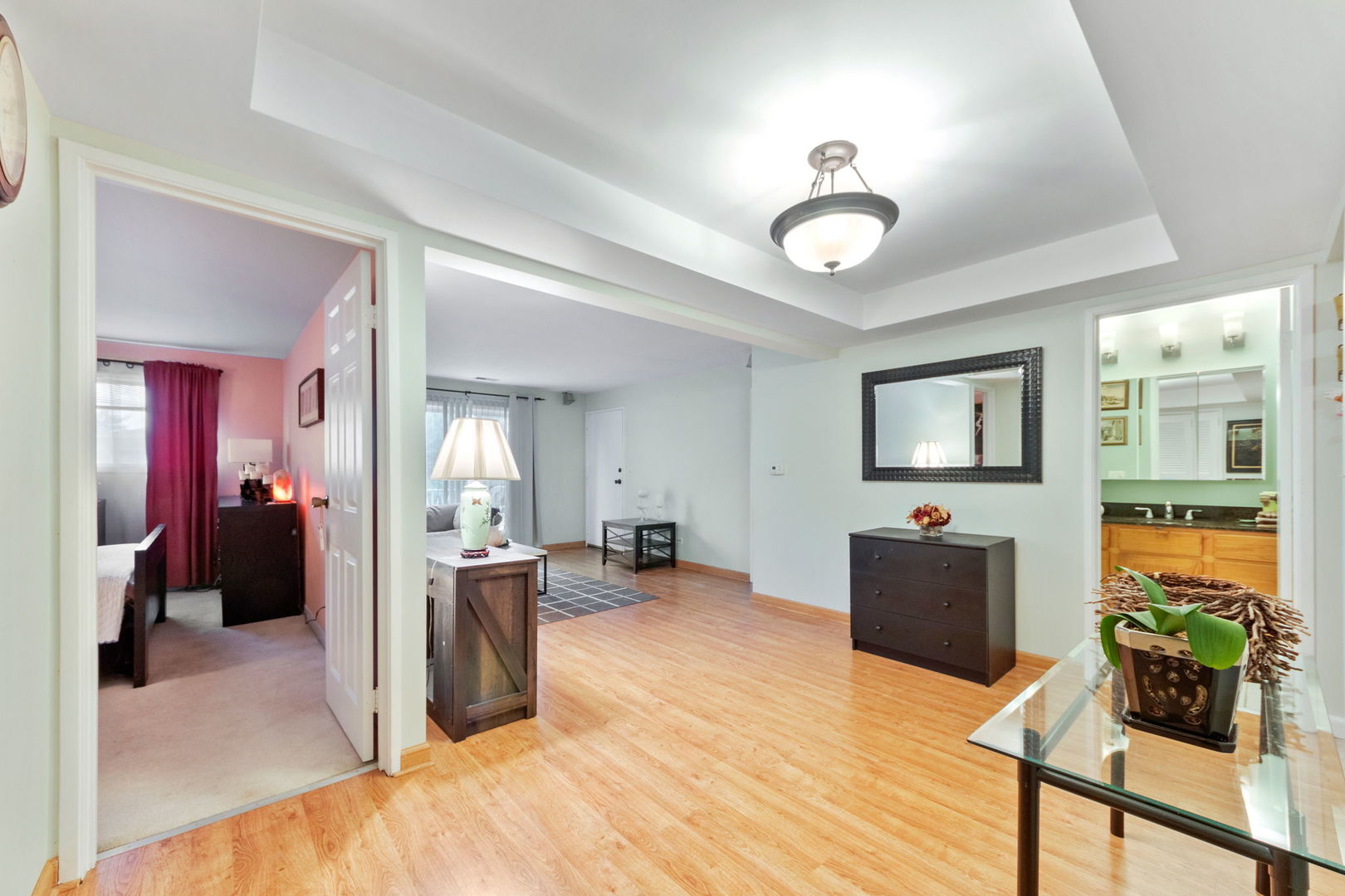 8559 West Rascher Avenue, Unit 3N Chicago, IL 60656 - Photo 6 of 15 a view of a livingroom with furniture cabinet mirror and workspace
