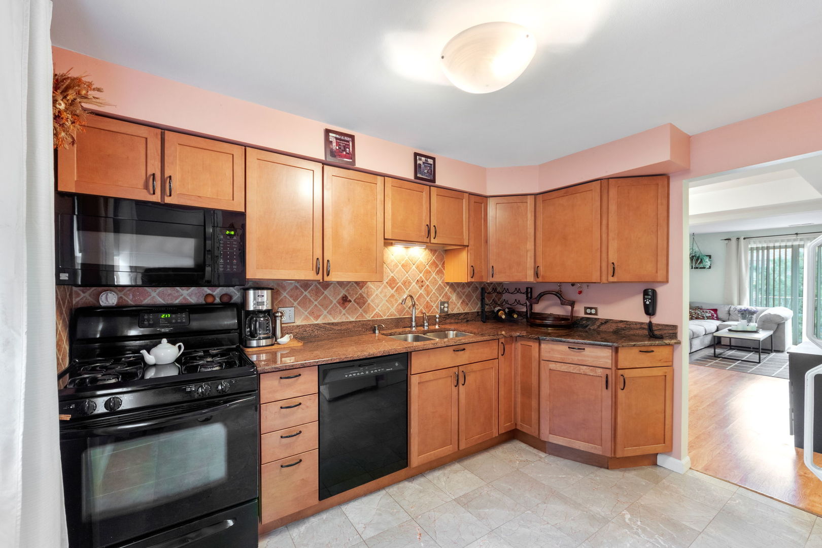 8559 West Rascher Avenue, Unit 3N Chicago, IL 60656 - Photo 9 of 15 a kitchen with stainless steel appliances a stove sink microwave and cabinets