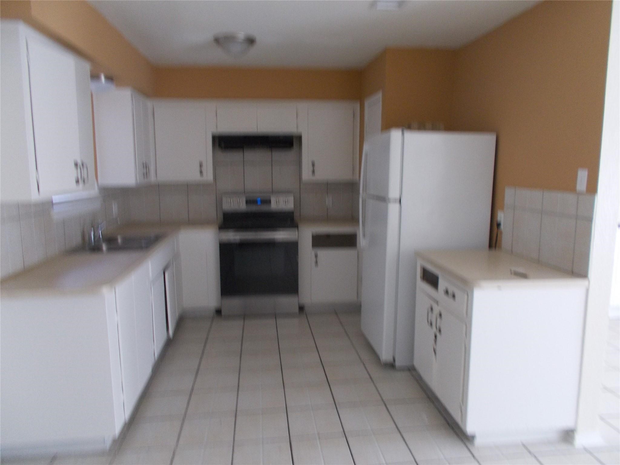 1923 Ojeman Road Houston, TX 77080 - Photo 11 of 14 a kitchen with a cabinets and steel stainless steel appliances
