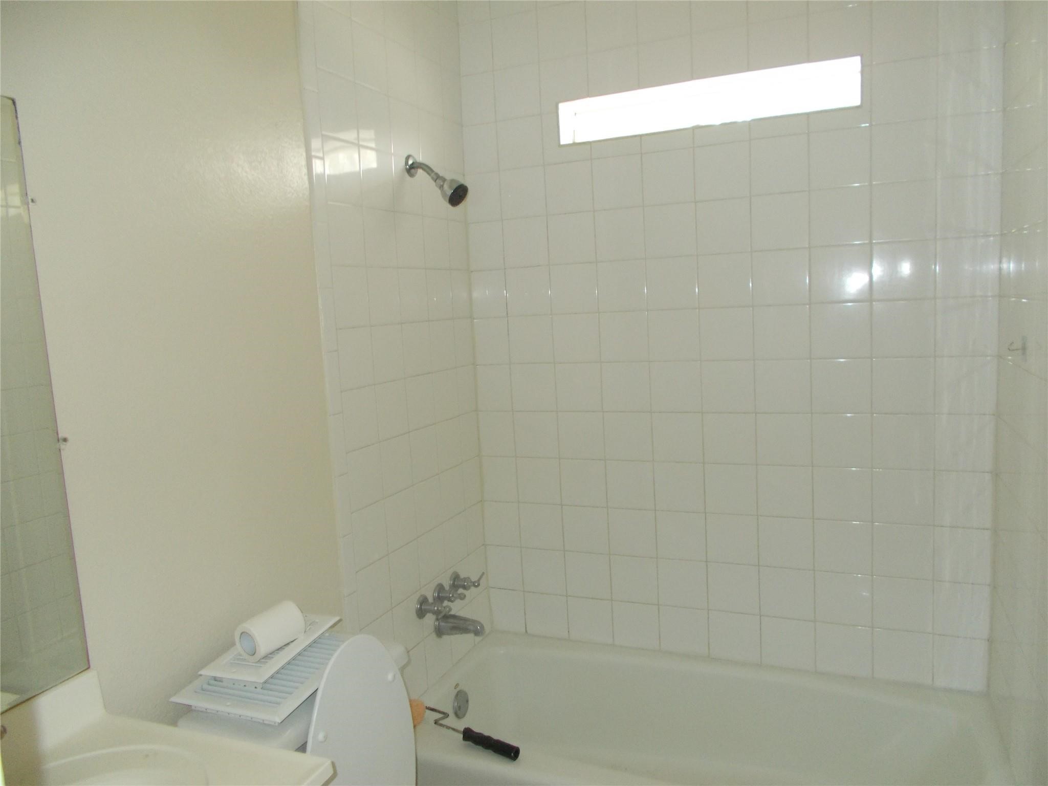 1923 Ojeman Road Houston, TX 77080 - Photo 5 of 14 a bathroom with a shower and toilet