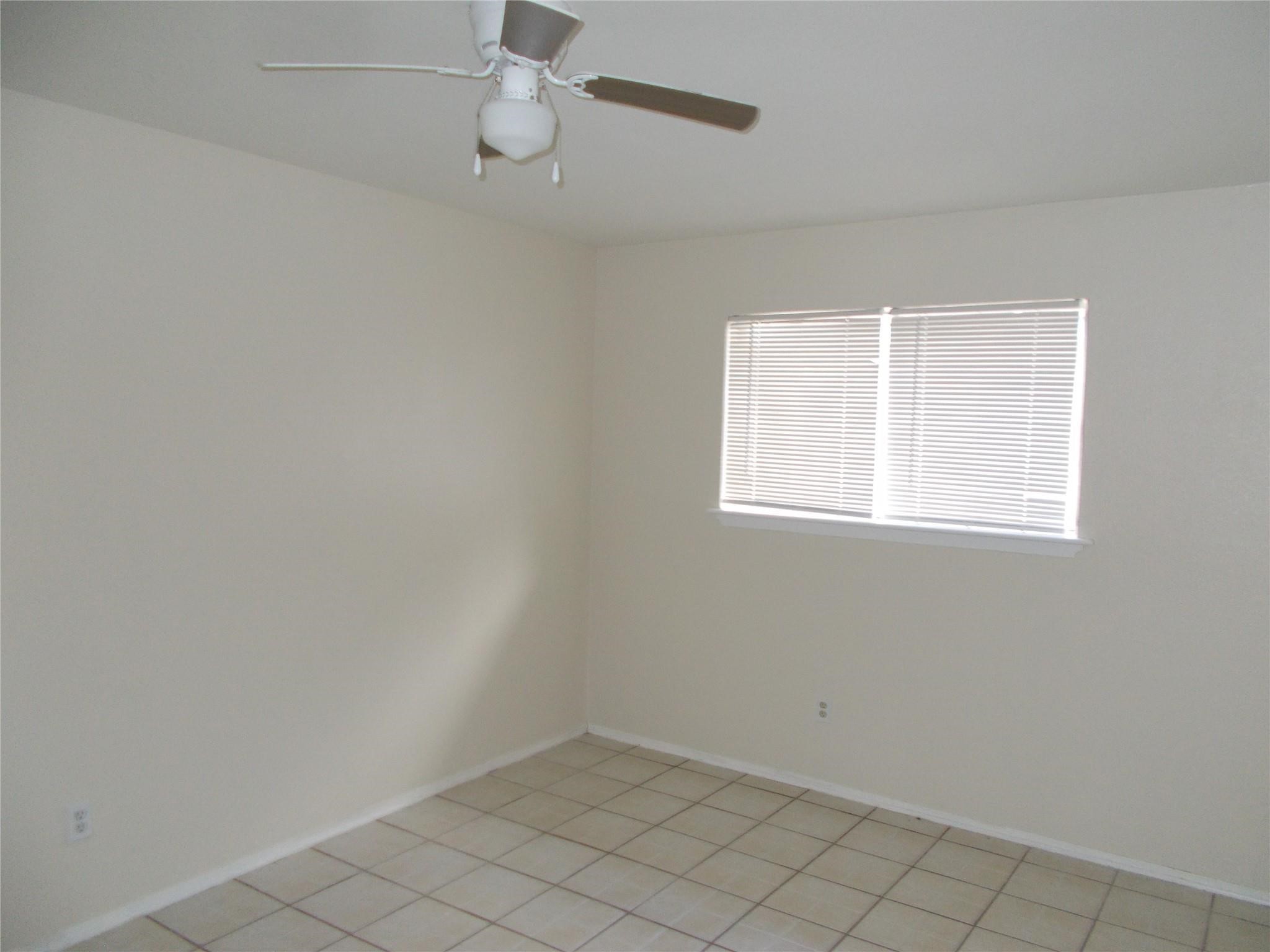1923 Ojeman Road Houston, TX 77080 - Photo 9 of 14 an empty room with a window