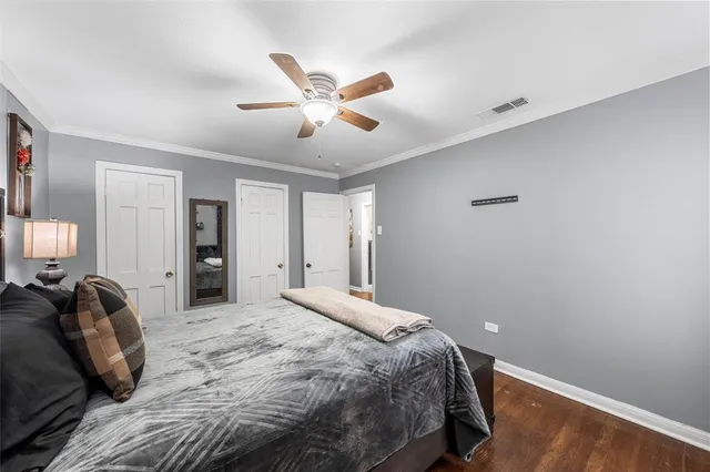a bedroom with a large bed and a chandelier