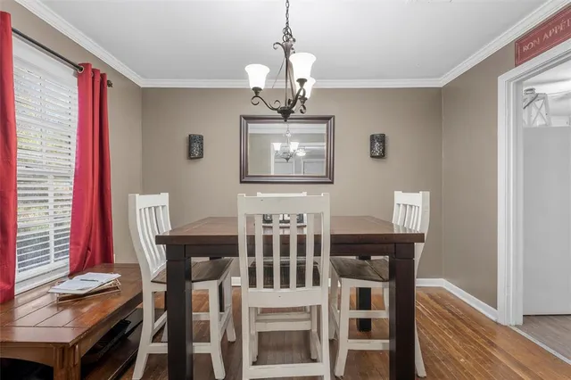 a view of a dining room with furniture and chandelier