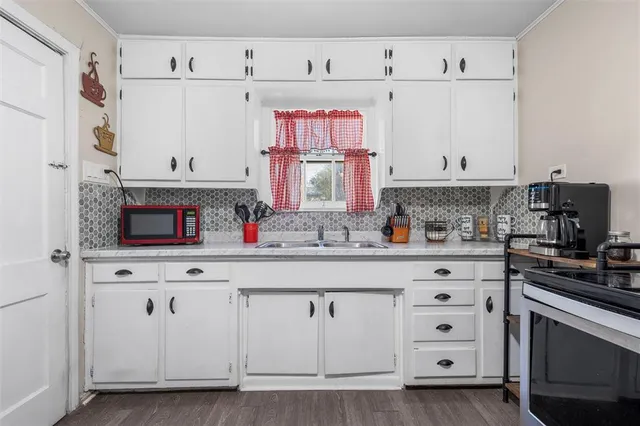 a kitchen with white cabinets and white appliances