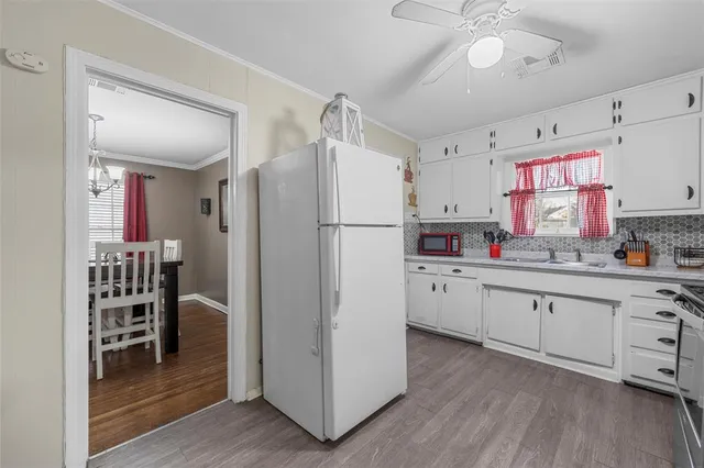 a kitchen with white cabinets and white appliances