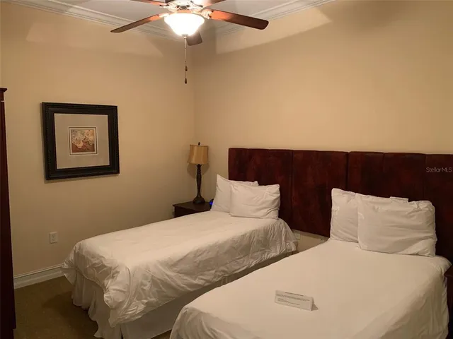 a bedroom with two beds and painting on the wall