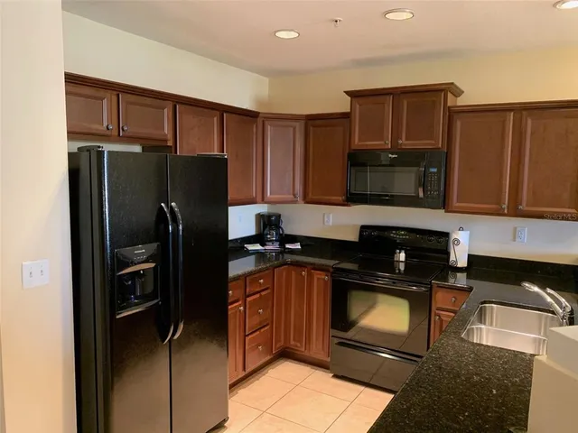 a kitchen with a refrigerator sink and microwave