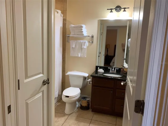 a bathroom with a toilet a sink and a mirror