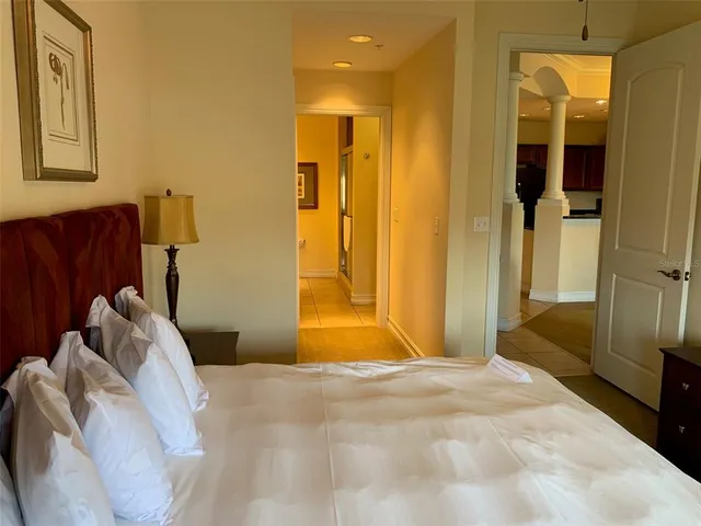 a bedroom with a bed and a mirror