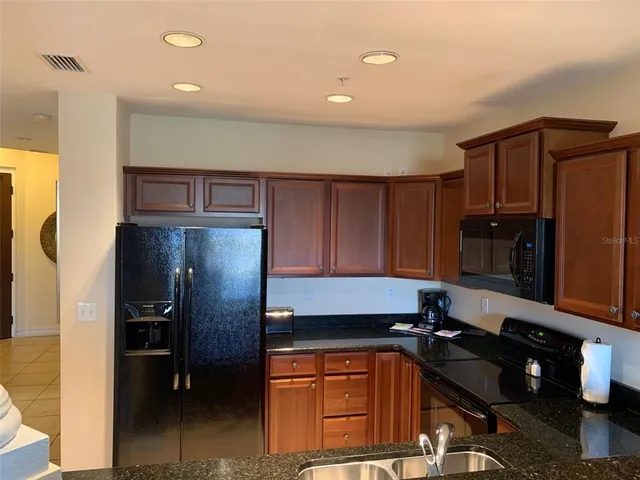 a kitchen with a refrigerator and a sink