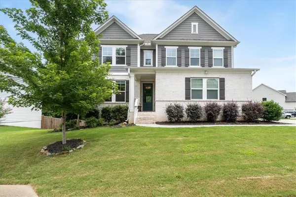 a front view of a house with a yard