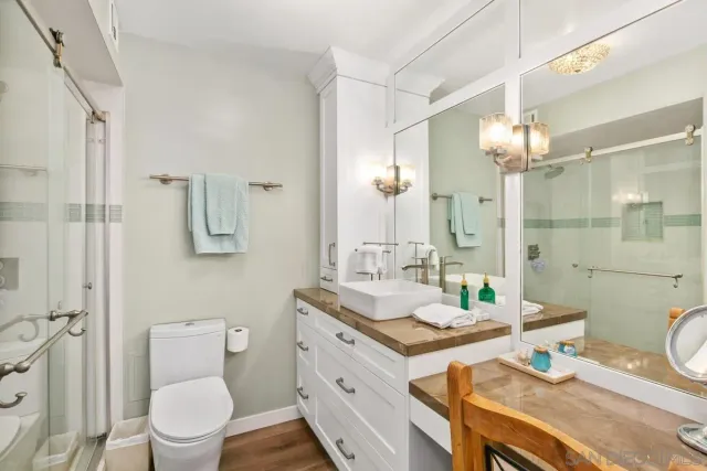 a bed sitting in a bedroom next to a window with a flat screen tv and a couch