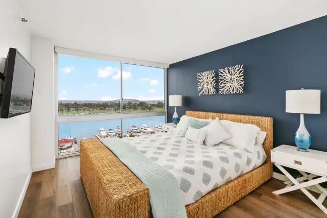 a living room with a bed and a flat screen tv