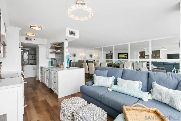 a living room with furniture wooden floor and a large window