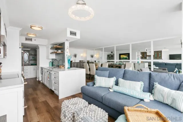 a living room with furniture wooden floor and a large window