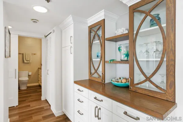 a bathroom with a granite countertop sink a toilet a mirror and shower