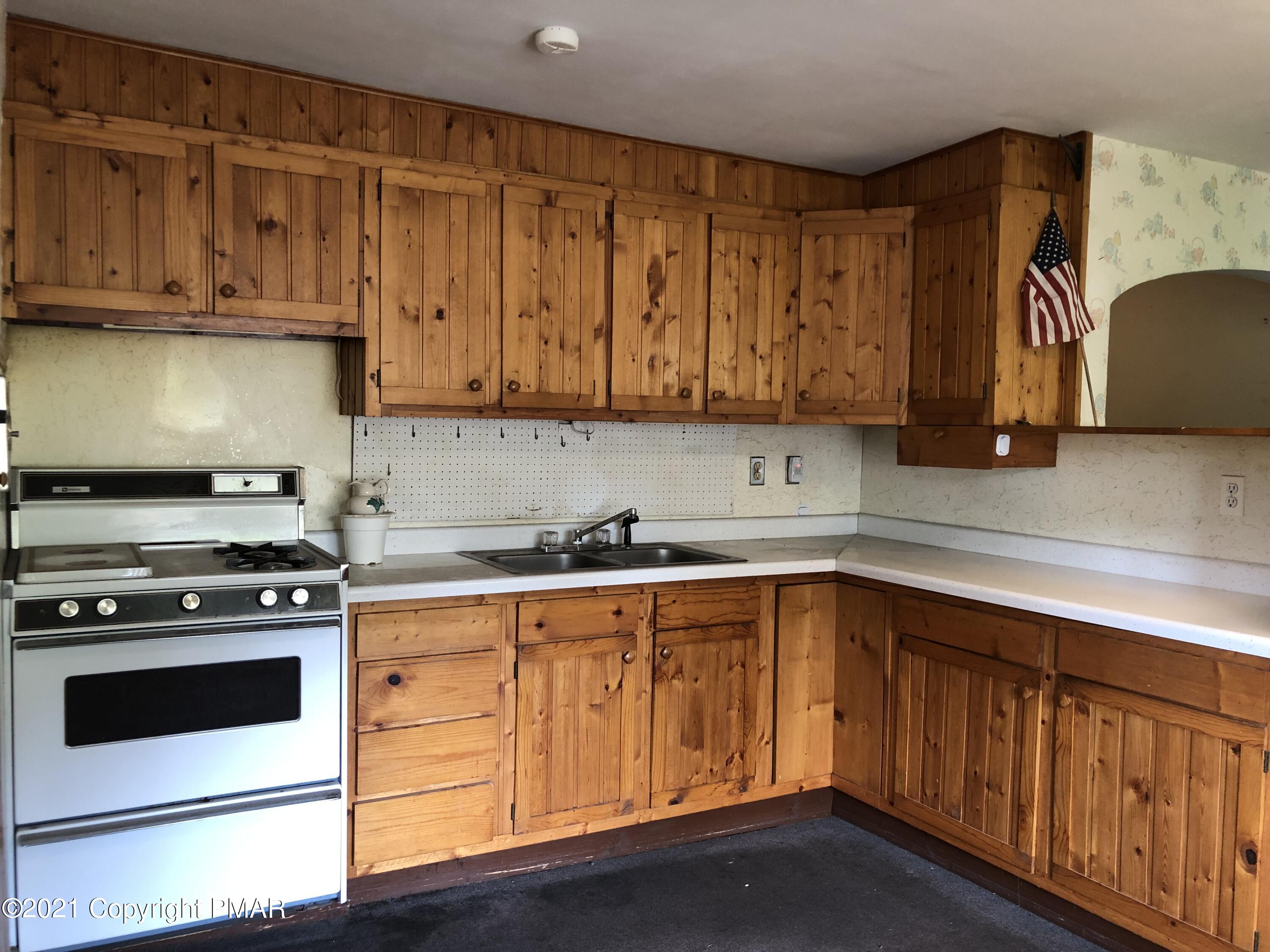 173 Anchorage Road Saylorsburg, PA 18353 - Photo 21 of 56 a kitchen with stainless steel appliances granite countertop a stove a sink and a microwave