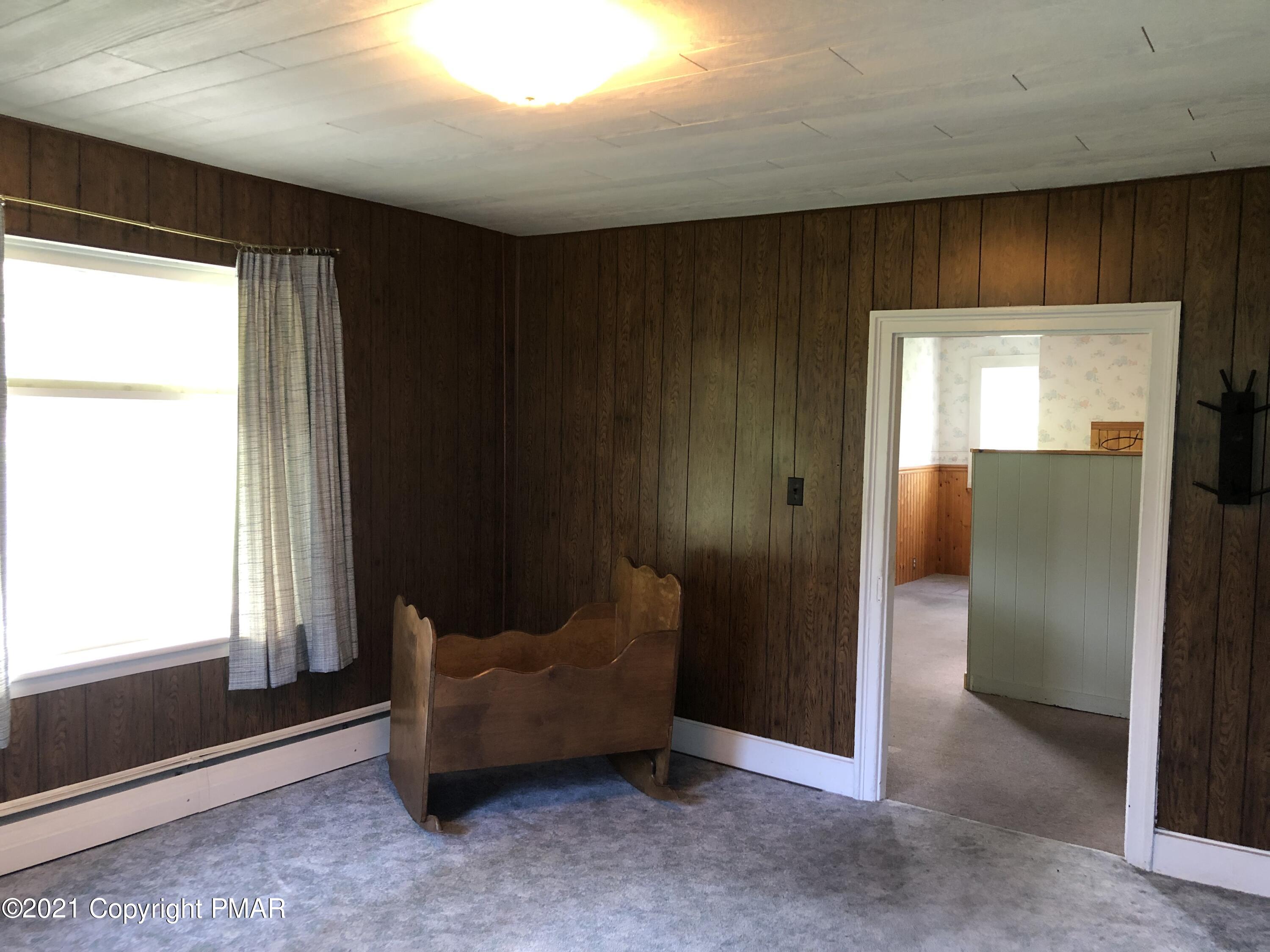 173 Anchorage Road Saylorsburg, PA 18353 - Photo 23 of 56 a living room with furniture and a window