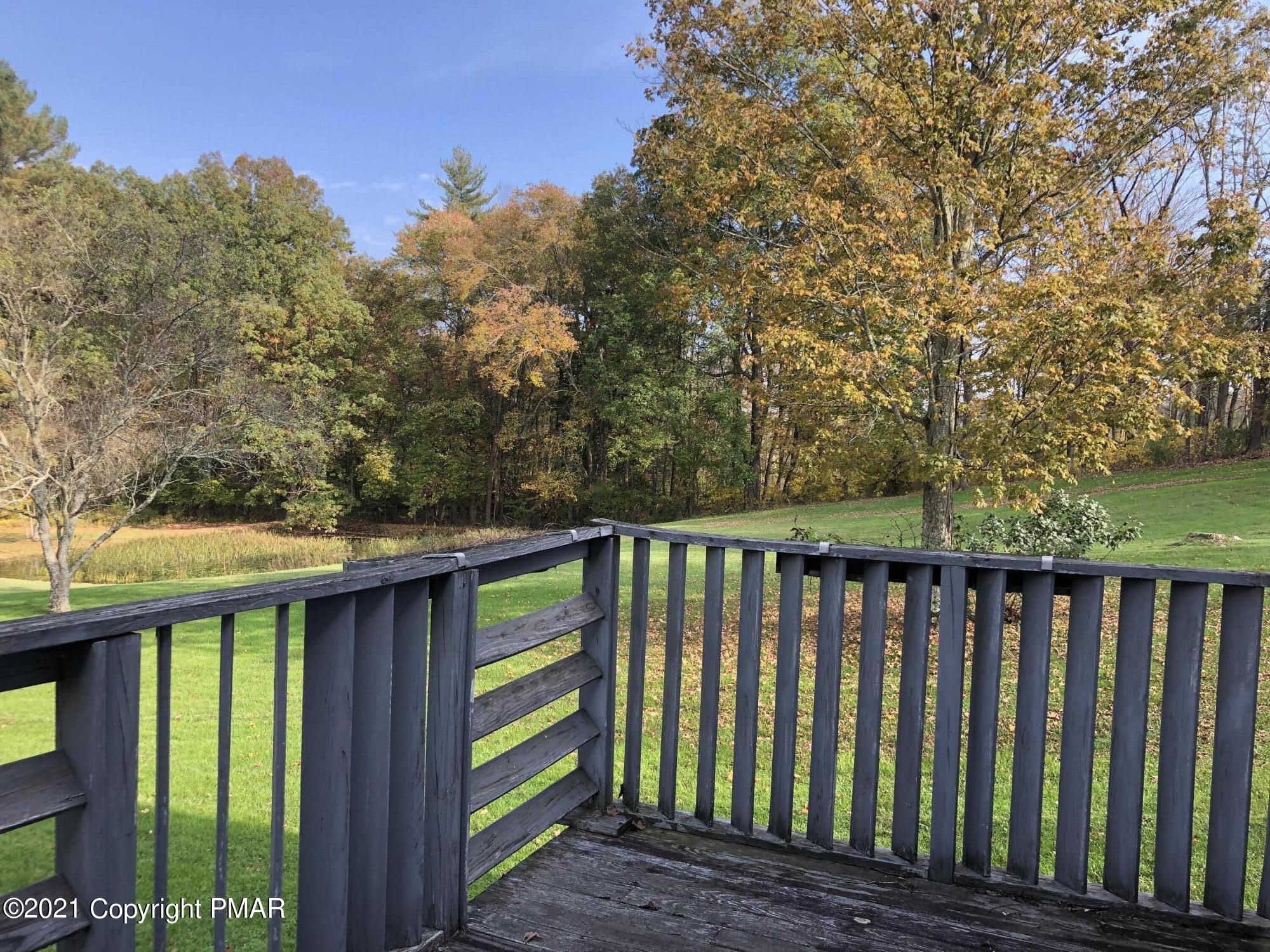 173 Anchorage Road Saylorsburg, PA 18353 - Photo 31 of 56 a balcony with wooden floor and yard in the back