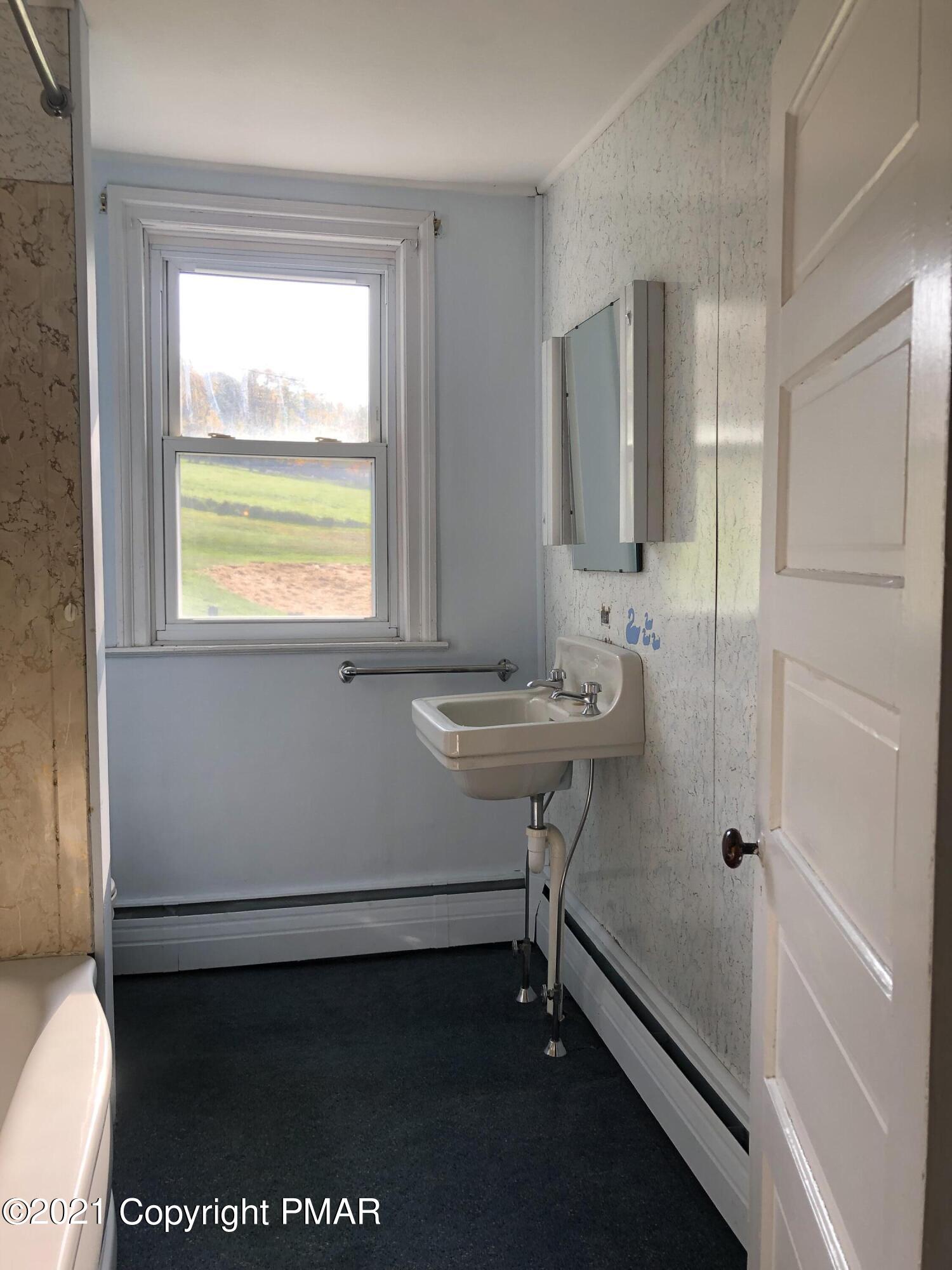 173 Anchorage Road Saylorsburg, PA 18353 - Photo 39 of 56 a bathroom with a sink a vanity and a mirror