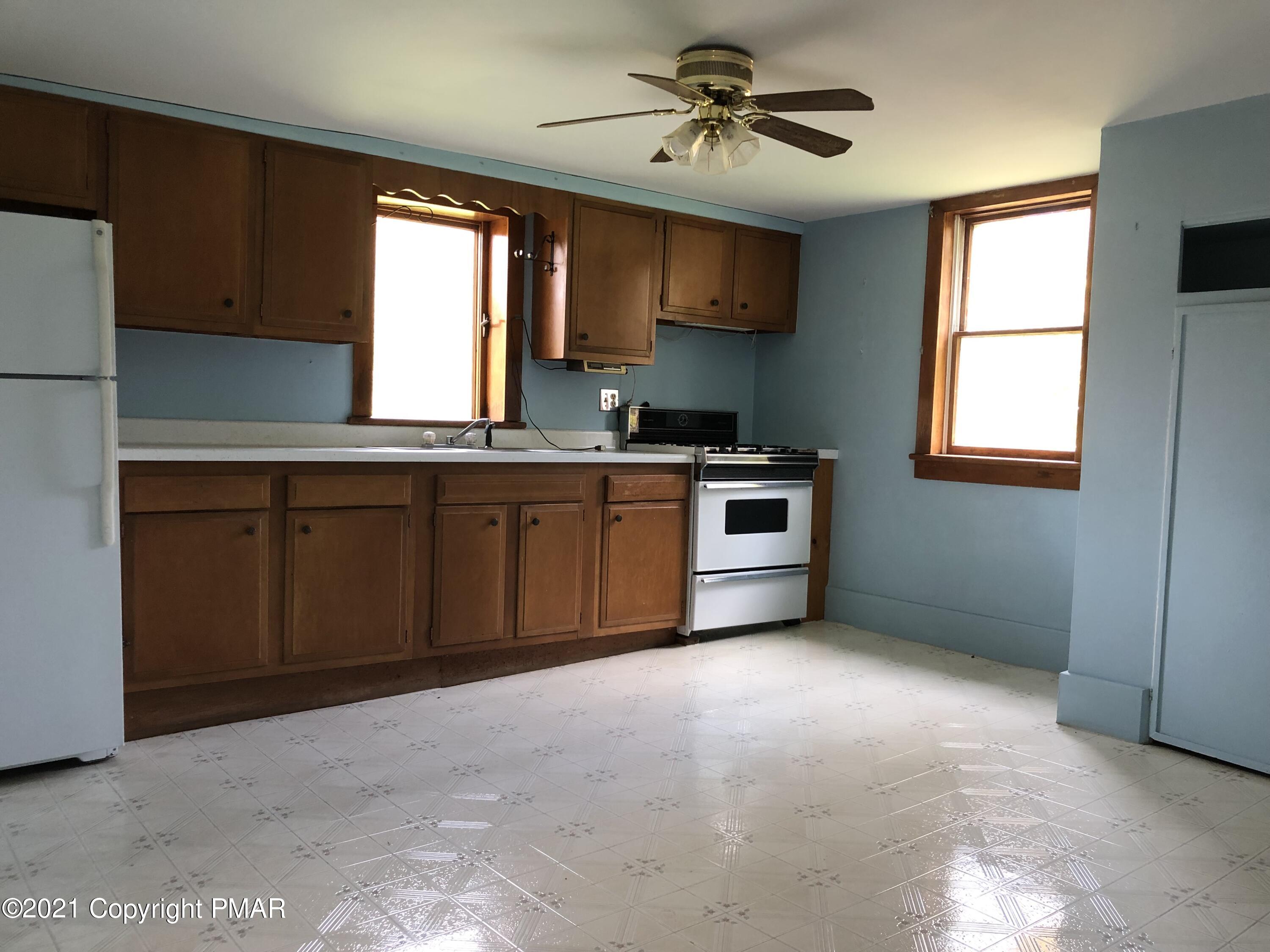173 Anchorage Road Saylorsburg, PA 18353 - Photo 43 of 56 a kitchen with stainless steel appliances granite countertop a stove sink and microwave