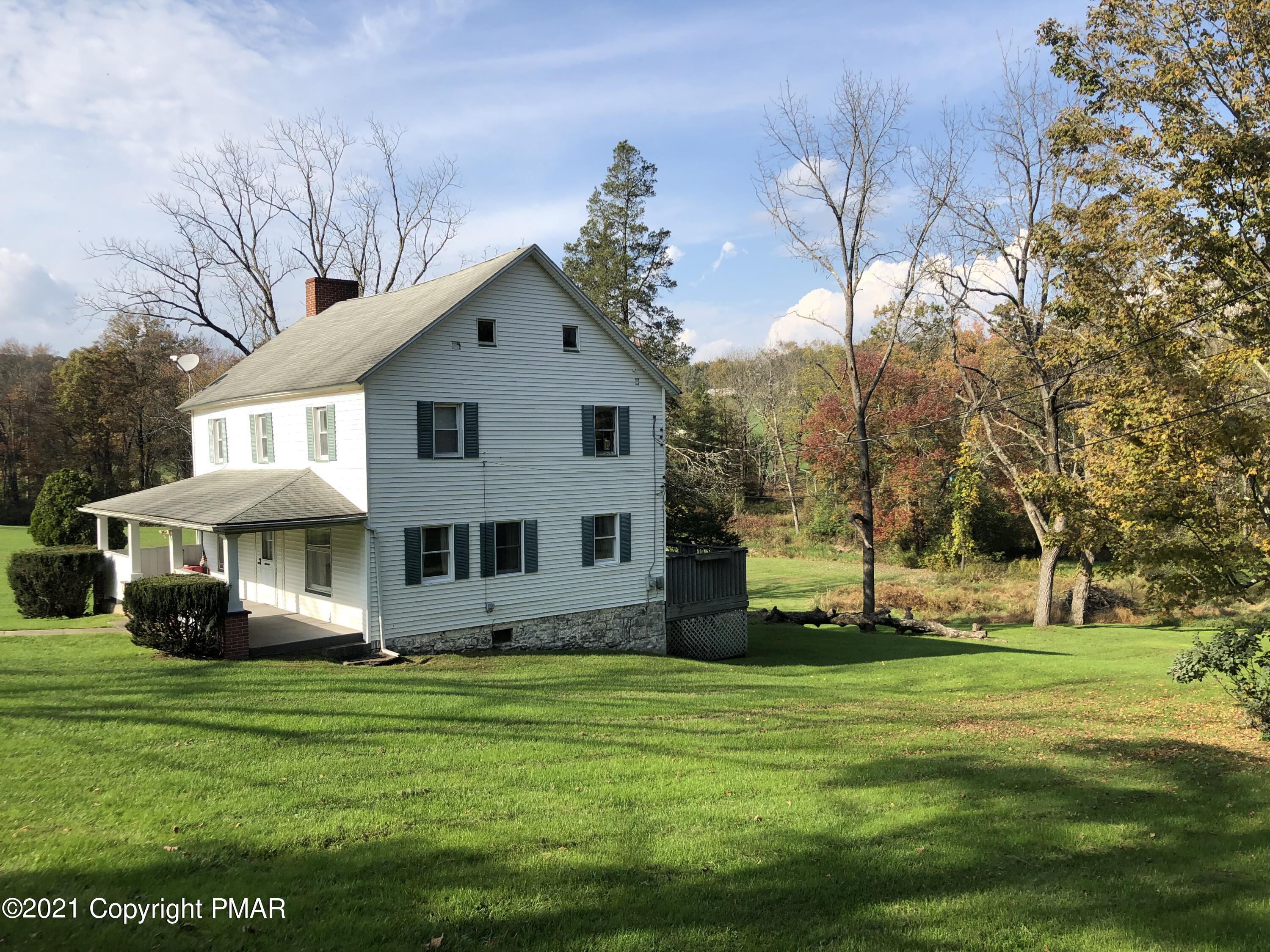 173 Anchorage Road Saylorsburg, PA 18353 - Photo 5 of 56 a front view of house with a garden and trees