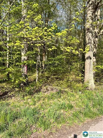 a backyard of a house with barbeque oven table and chairs