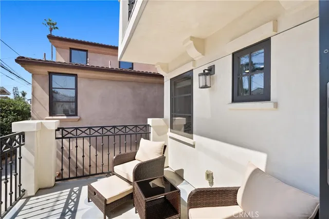a balcony with wooden floor and furniture