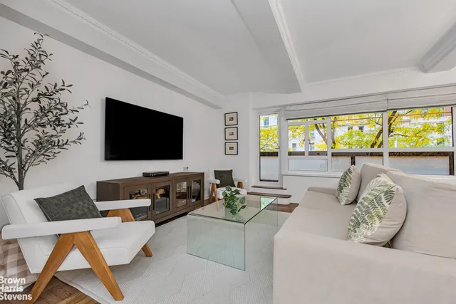 a living room with couches and a flat screen tv