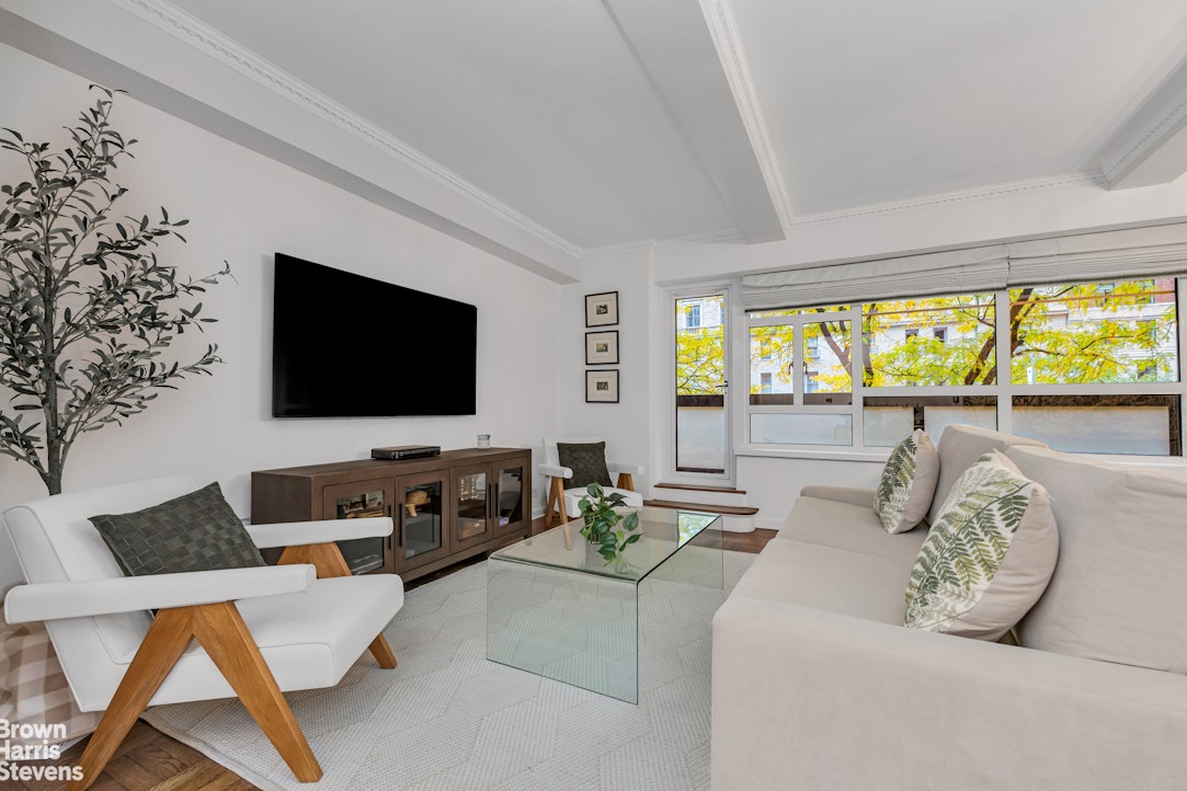 a living room with couches and a flat screen tv