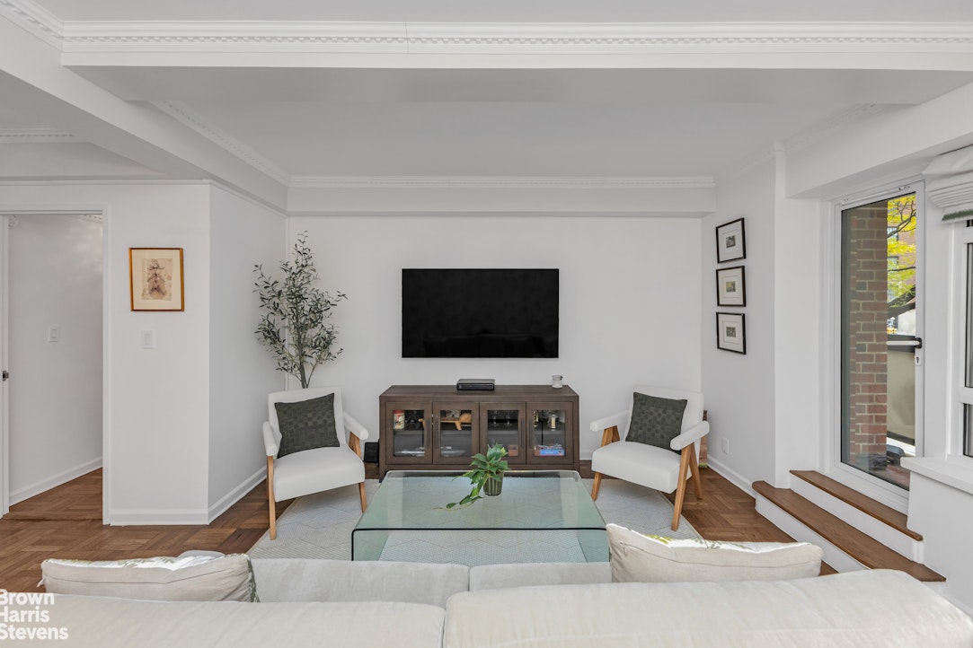 750 Park Avenue, Unit 3B Manhattan, NY 10021 - Photo 3 of 13 a living room with furniture and a flat screen tv