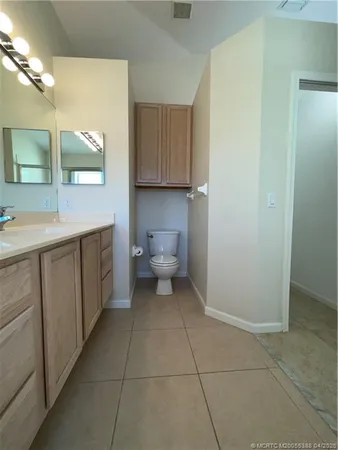 a bathroom with a sink a toilet and mirror