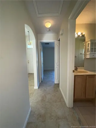 hallway with wooden floor and bathroom
