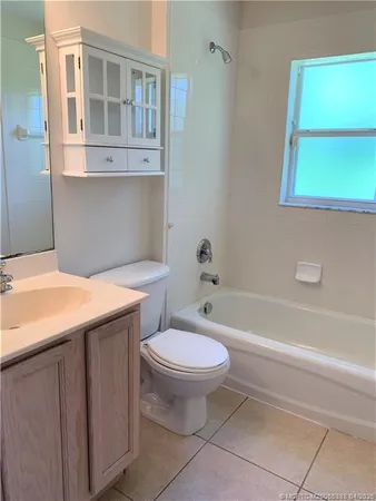 a bathroom with a granite countertop toilet a sink and bathtub