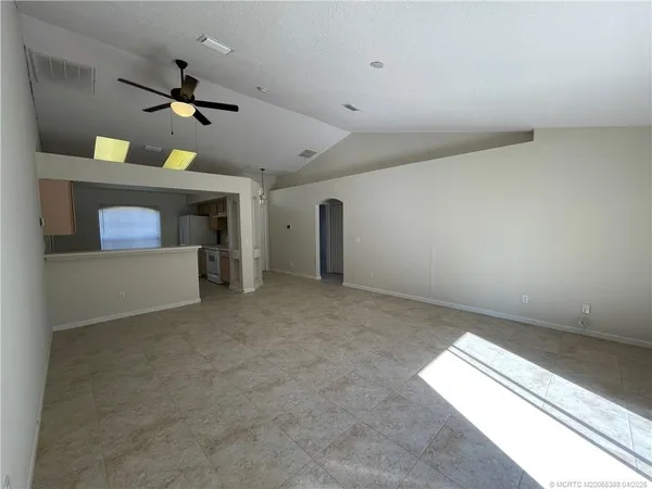 an empty room with a empty space and a ceiling fan