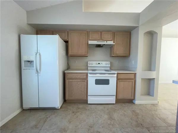 a white refrigerator freezer sitting inside of a kitchen