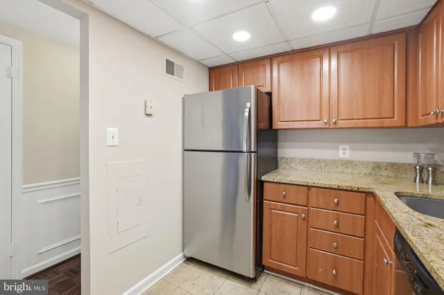 a kitchen with a refrigerator and cabinets