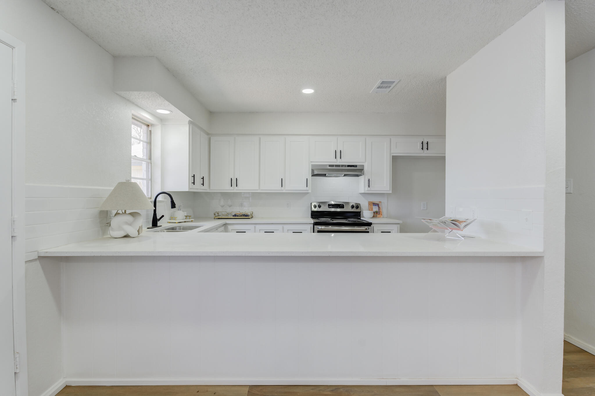 2314 77th Street Lubbock, TX 79423 - Photo 13 of 41 a kitchen with stainless steel appliances granite countertop a sink a stove and a refrigerator