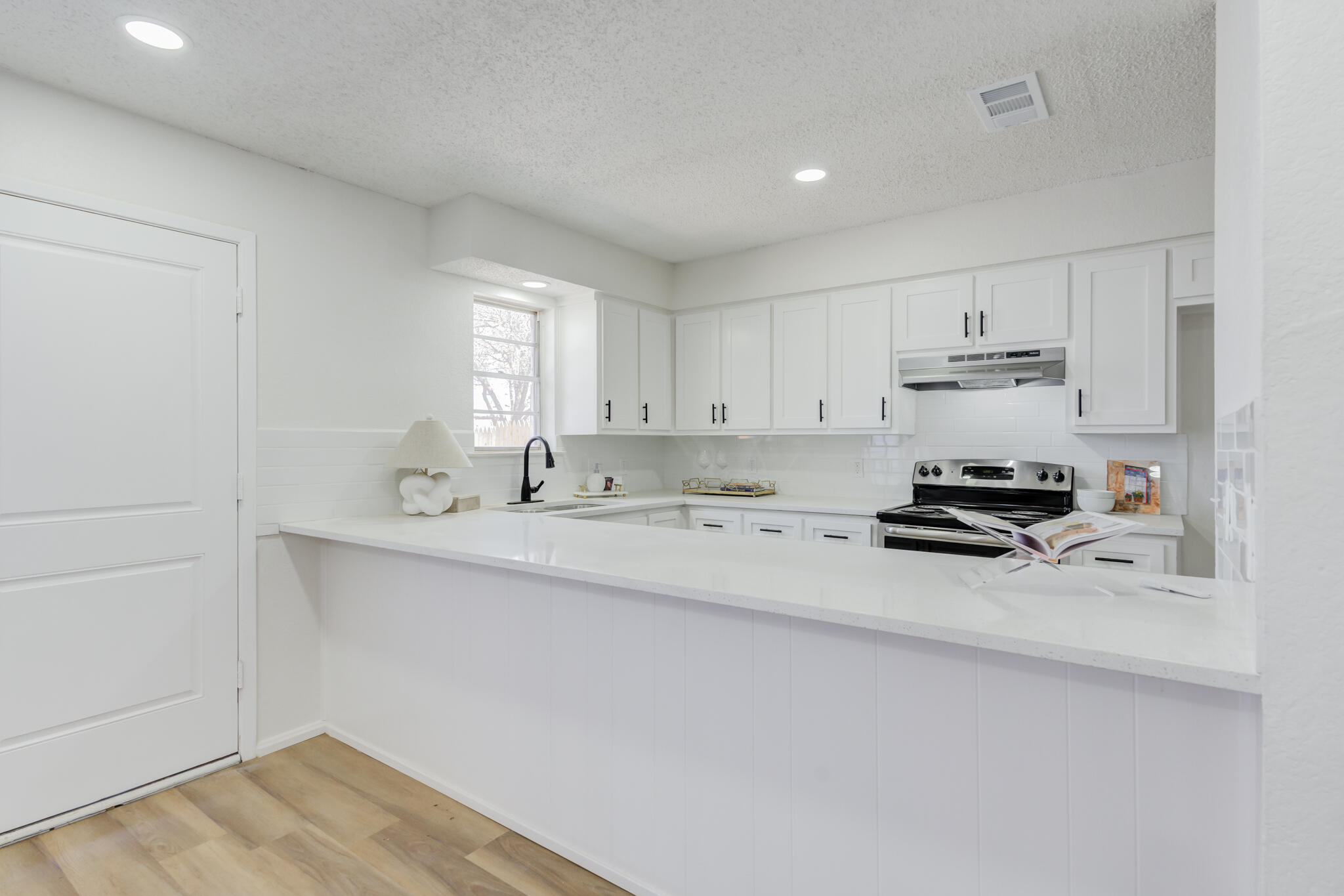 2314 77th Street Lubbock, TX 79423 - Photo 14 of 41 a kitchen with stainless steel appliances a sink stove and cabinets