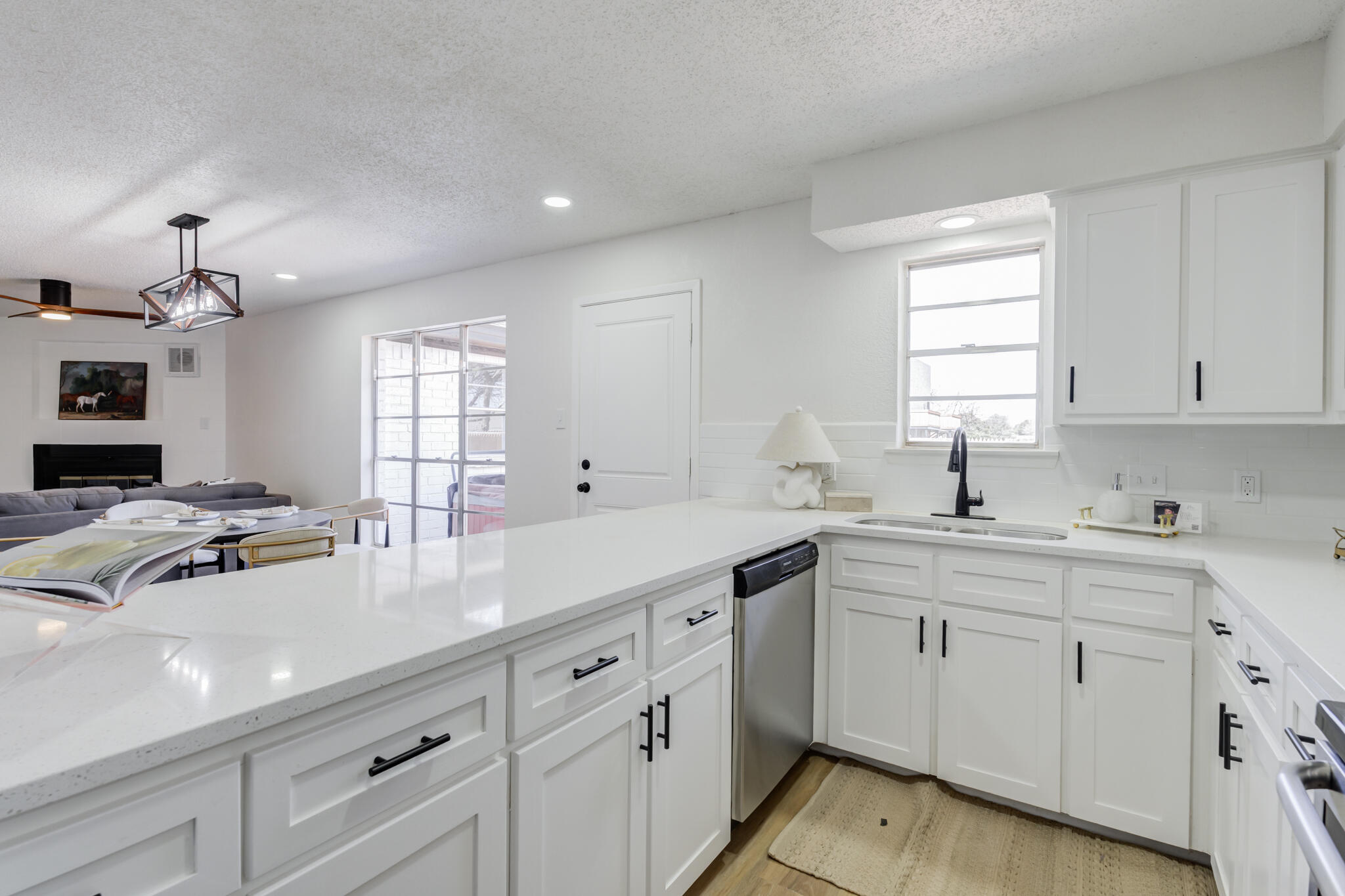 2314 77th Street Lubbock, TX 79423 - Photo 17 of 41 a kitchen with a sink stove and cabinets
